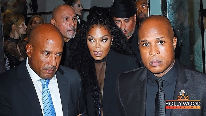 Janet Jackson surrounded by bodyguards during